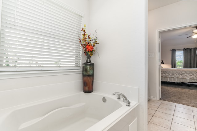 bathroom with tile patterned floors, tiled bath, and ceiling fan