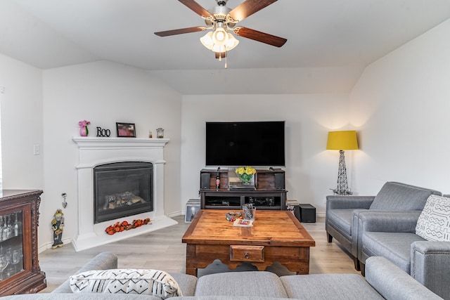 living room with ceiling fan, lofted ceiling, and light hardwood / wood-style floors