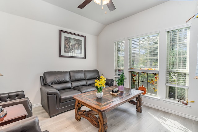 living room with lofted ceiling, ceiling fan, and light hardwood / wood-style flooring