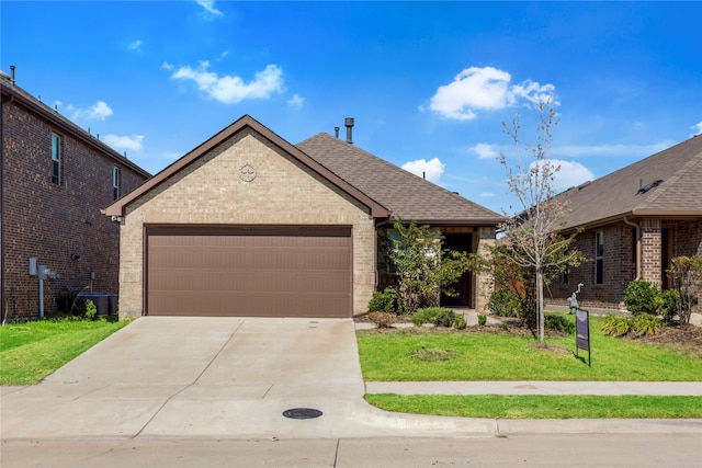 view of front of property featuring a garage and a front lawn