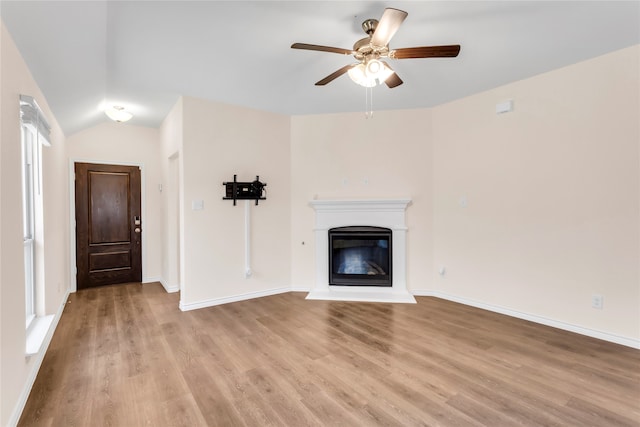 unfurnished living room featuring ceiling fan, vaulted ceiling, and light hardwood / wood-style flooring