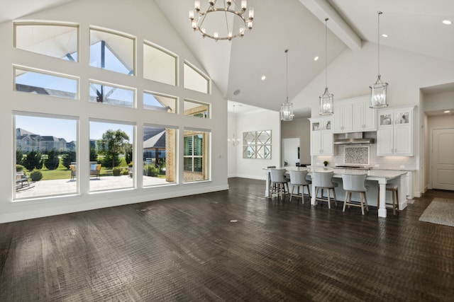 living room featuring high vaulted ceiling, beamed ceiling, and dark wood-type flooring