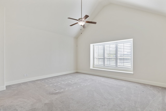 carpeted empty room with ceiling fan and high vaulted ceiling