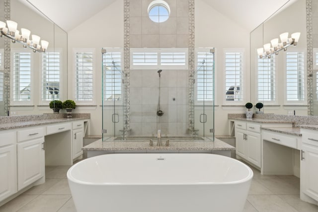 bathroom featuring vanity, lofted ceiling, independent shower and bath, and tile patterned flooring