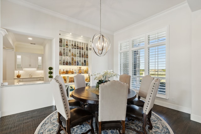 dining area featuring dark wood-type flooring, crown molding, and an inviting chandelier