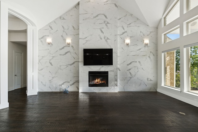 unfurnished living room with tile walls and a high end fireplace