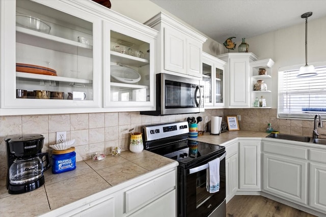 kitchen featuring sink, white cabinets, light hardwood / wood-style flooring, and stainless steel appliances