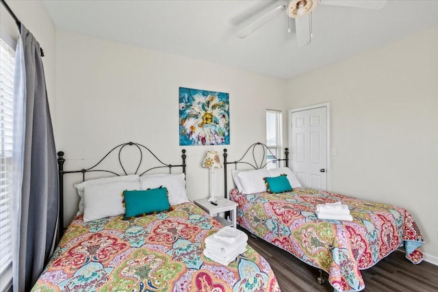 bedroom with baseboards, a ceiling fan, and wood finished floors