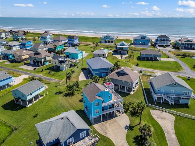 drone / aerial view featuring a water view and a view of the beach