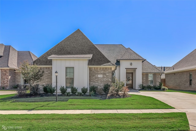 french country home with a front lawn