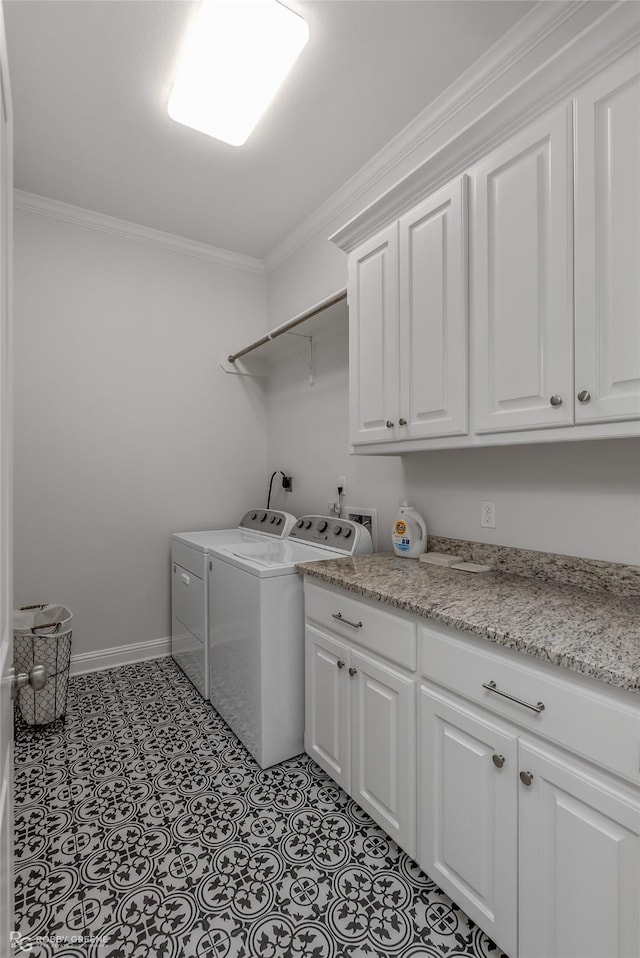 clothes washing area featuring separate washer and dryer, light tile patterned floors, crown molding, and cabinets