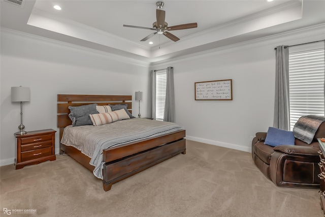 bedroom featuring a raised ceiling, crown molding, light colored carpet, and ceiling fan