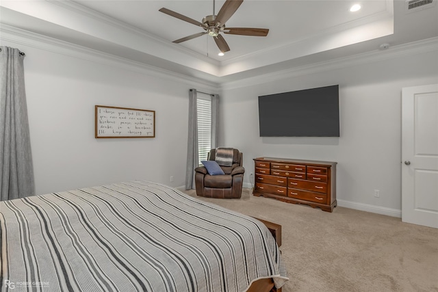 bedroom with a raised ceiling, crown molding, light carpet, and ceiling fan