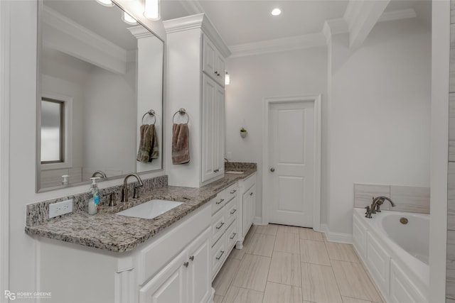 bathroom with vanity, a bathtub, and crown molding