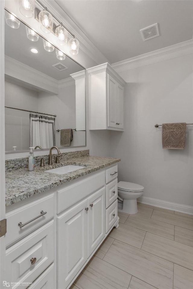 bathroom with ornamental molding, curtained shower, vanity, and toilet