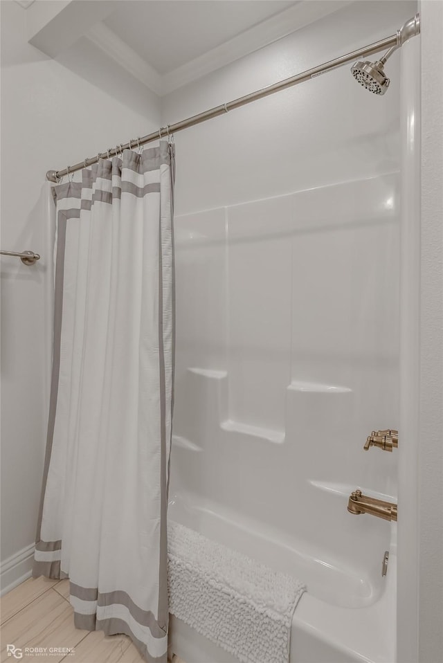 bathroom with walk in shower and ornamental molding