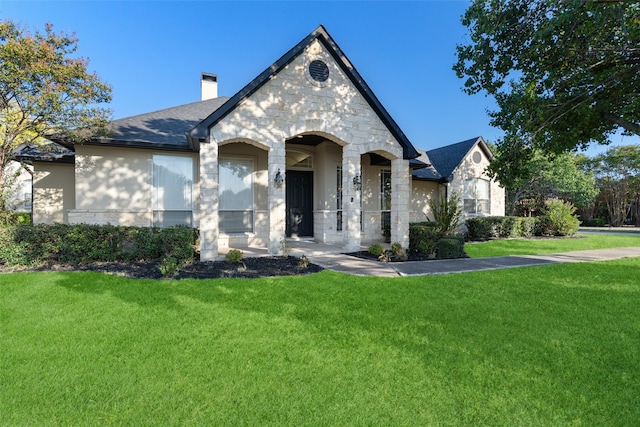 french country home with a front lawn