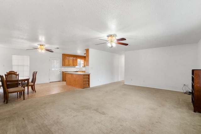 carpeted living room featuring a textured ceiling and ceiling fan