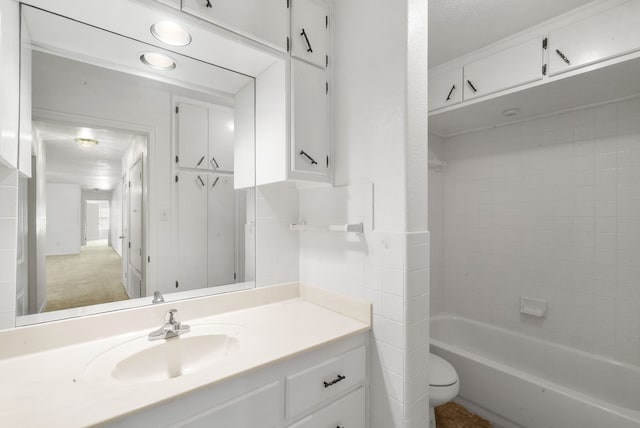 full bathroom with vanity, shower / washtub combination, a textured ceiling, and toilet