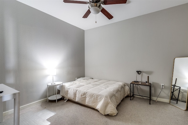 carpeted bedroom with ceiling fan and vaulted ceiling