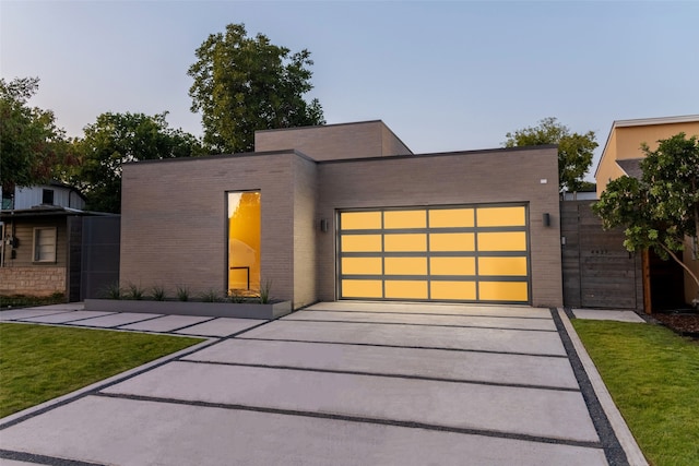 modern home featuring a front lawn and a garage