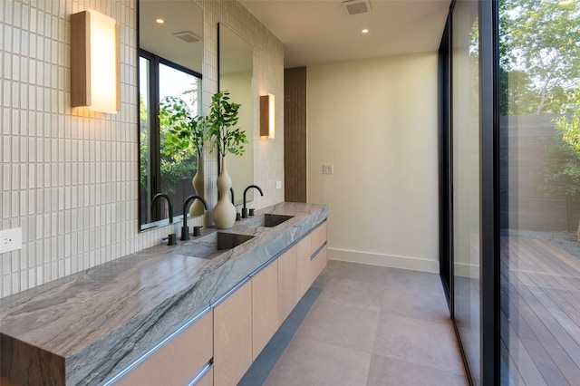 bathroom featuring vanity and tile walls