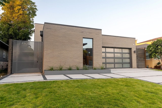 contemporary house with a front yard and a garage