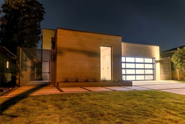 modern home with a yard and a garage