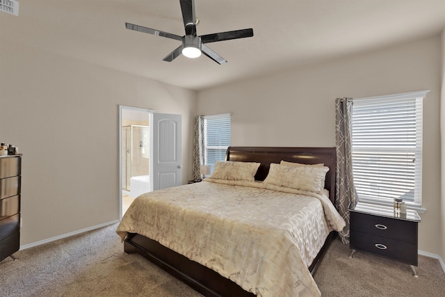 bedroom with ensuite bathroom, ceiling fan, and carpet flooring