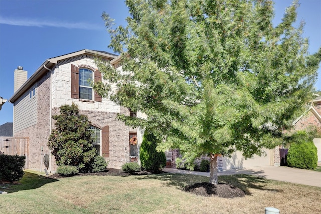 view of front of house with a garage and a front lawn