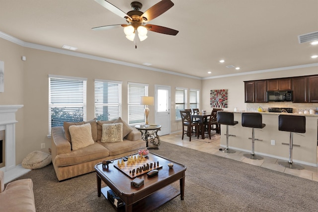 tiled living room featuring ornamental molding and ceiling fan