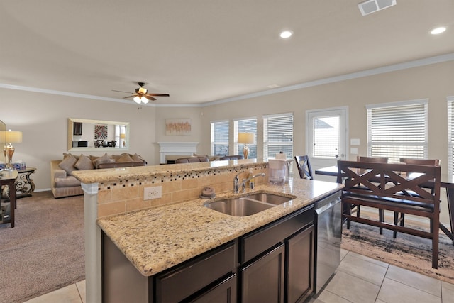 kitchen with crown molding, light carpet, light stone countertops, sink, and dishwasher