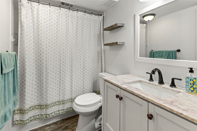 bathroom featuring vanity, toilet, and curtained shower