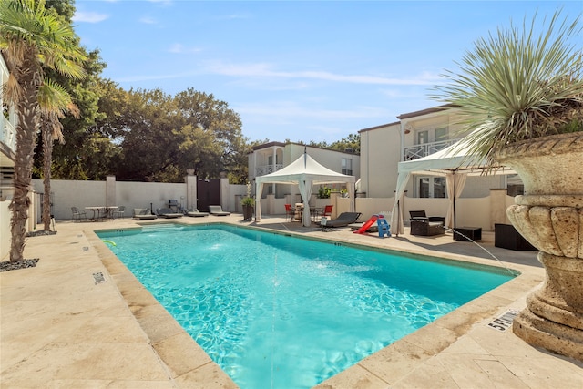 view of swimming pool featuring a gazebo and a patio