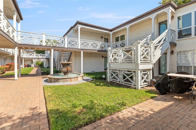 exterior space featuring a patio area and a lawn