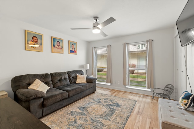 living room featuring light hardwood / wood-style floors and ceiling fan