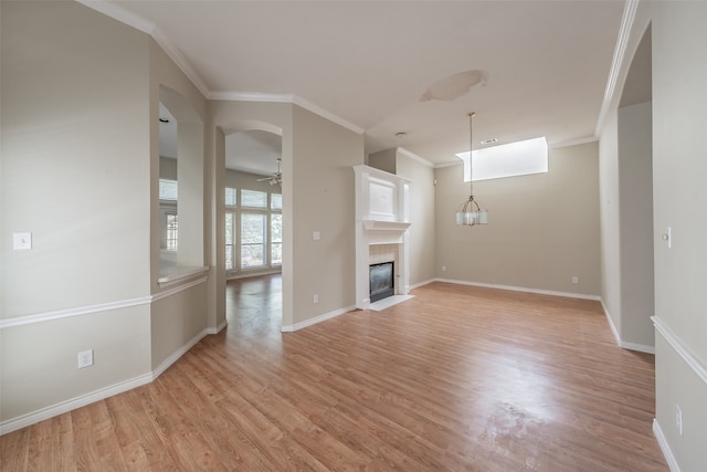 unfurnished living room featuring ornamental molding, light hardwood / wood-style flooring, and ceiling fan