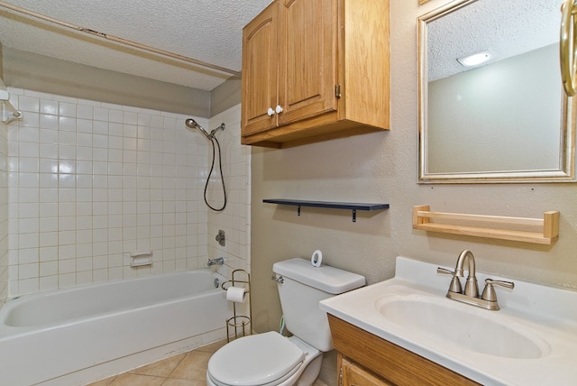 full bathroom with a textured ceiling, toilet, vanity, tiled shower / bath combo, and tile patterned flooring