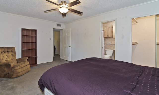 bedroom featuring ensuite bathroom, carpet flooring, a textured ceiling, and ceiling fan