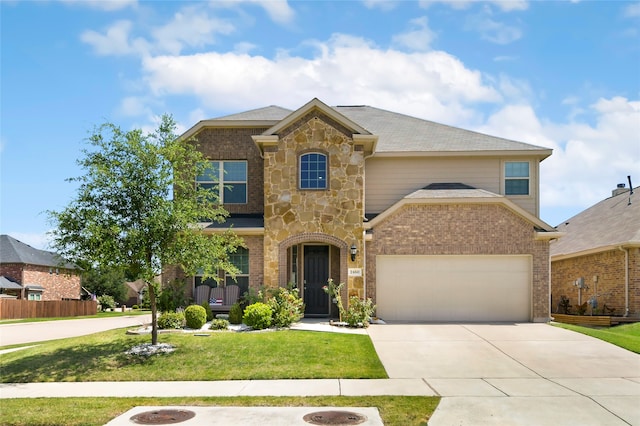 view of front of home featuring a front yard and a garage