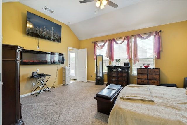 bedroom with vaulted ceiling, light colored carpet, and ceiling fan