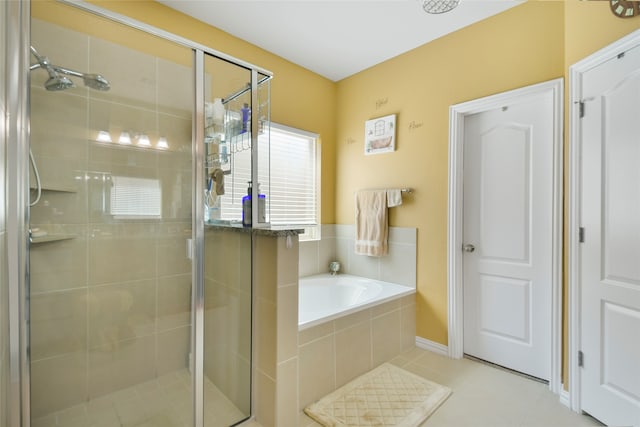 bathroom with separate shower and tub and tile patterned flooring