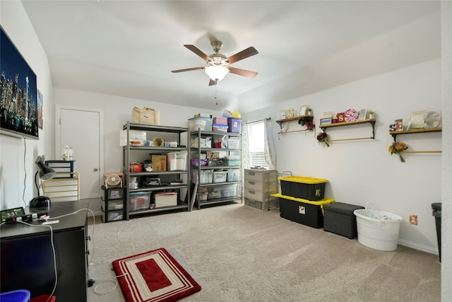 interior space featuring light carpet and ceiling fan