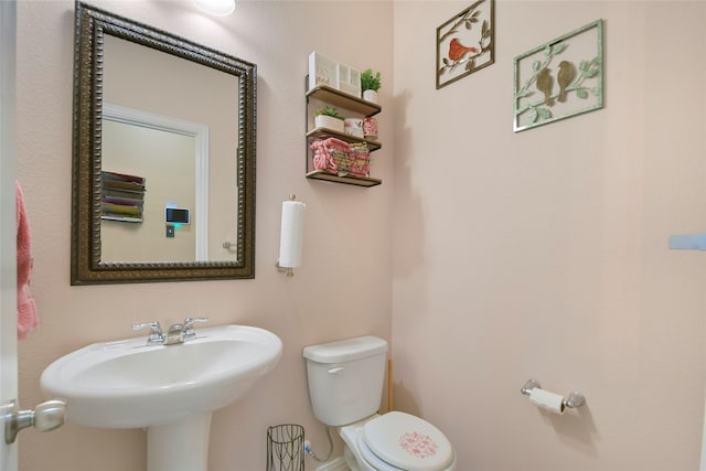 bathroom featuring sink and toilet