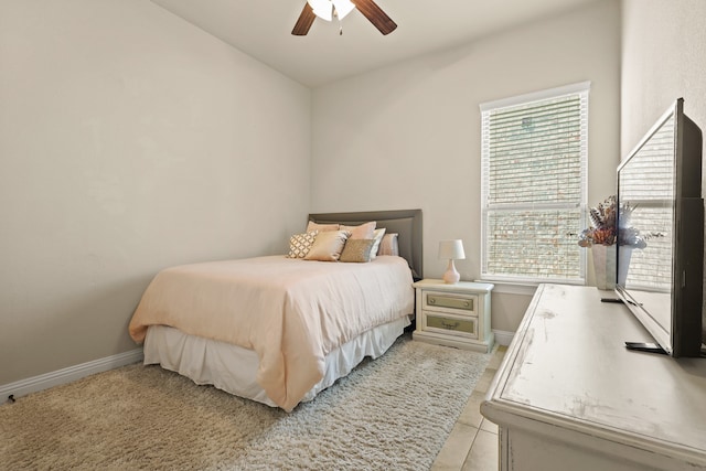 bedroom with light tile patterned floors and ceiling fan