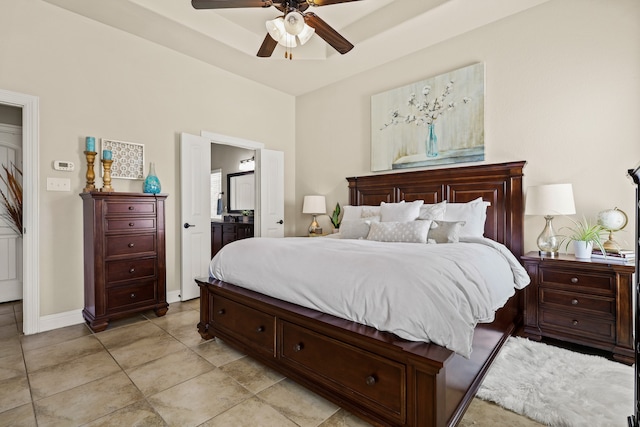 tiled bedroom with ensuite bathroom and ceiling fan