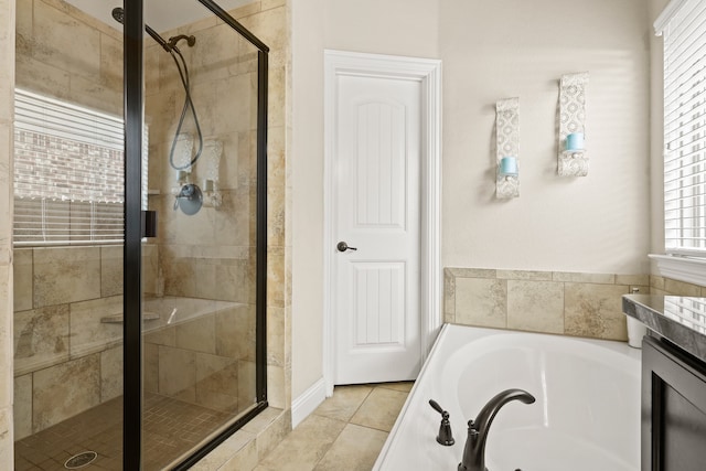 bathroom with vanity, shower with separate bathtub, and tile patterned flooring