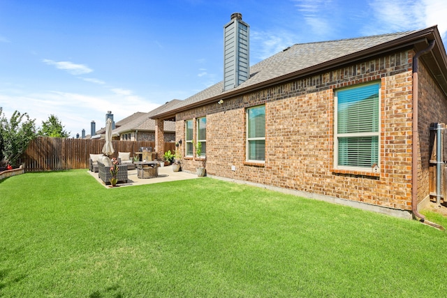 rear view of property with an outdoor living space, a yard, and a patio area