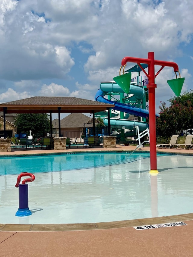 view of pool featuring a patio and a water slide