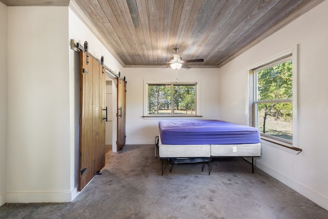 bedroom featuring a barn door, ceiling fan, and wooden ceiling